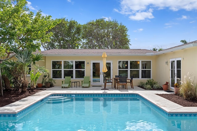 view of swimming pool featuring french doors and a patio