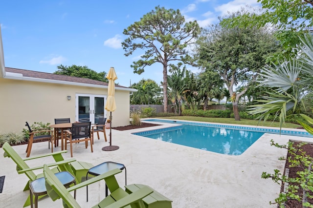 view of pool featuring a patio and french doors