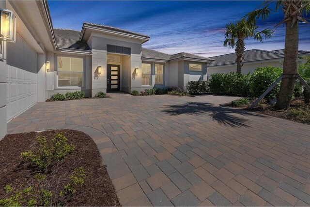 view of front of property featuring french doors and a lawn