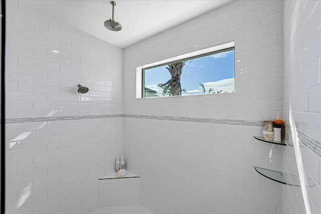 full bath with a tile shower