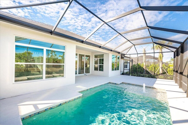 pool featuring a patio area and glass enclosure