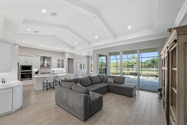 living room with light wood-type flooring, visible vents, and recessed lighting