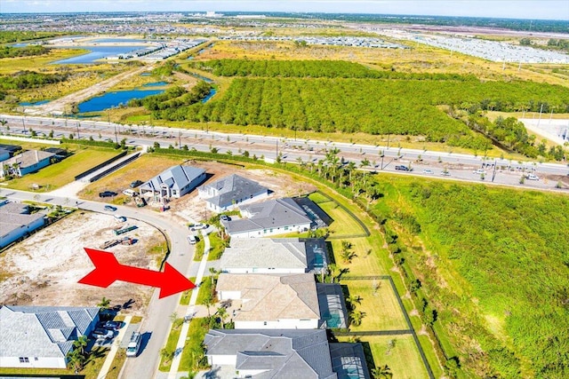 birds eye view of property featuring a water view and a residential view