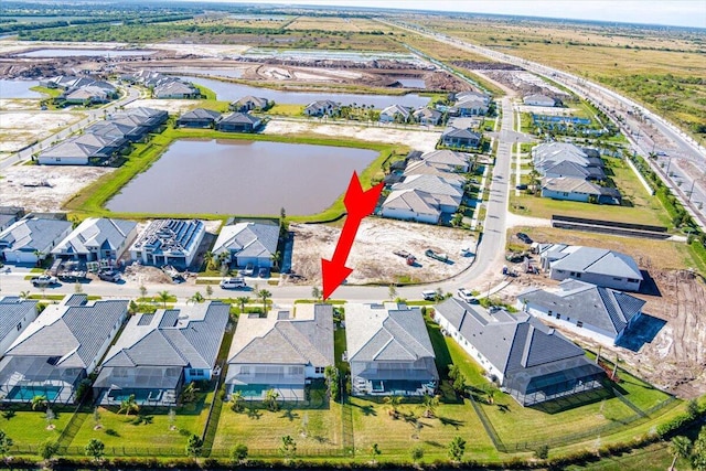 drone / aerial view featuring a residential view and a water view