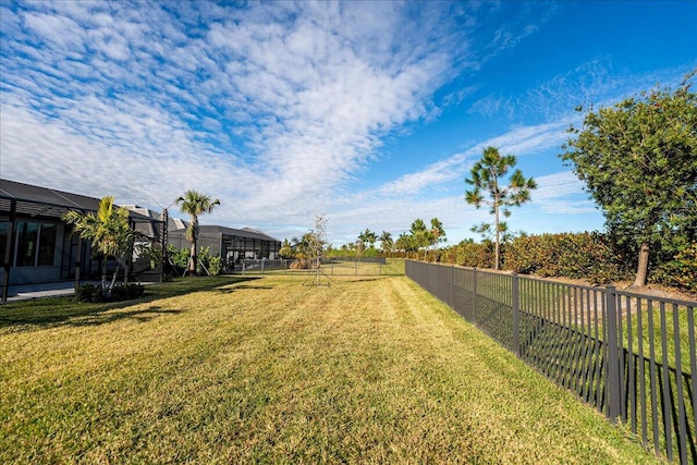 view of yard featuring a lanai and a fenced backyard