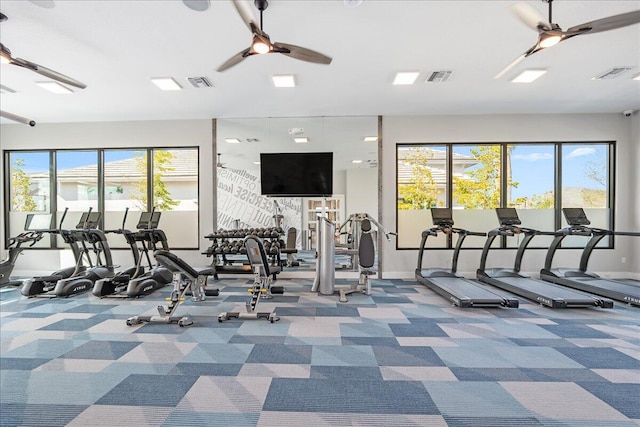 workout area featuring visible vents, carpet floors, and a ceiling fan