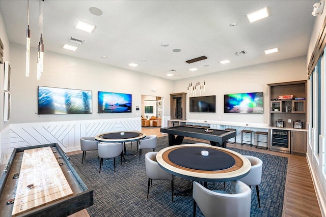 playroom with wood finished floors, beverage cooler, and visible vents