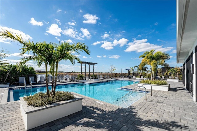 pool featuring a patio and a pergola