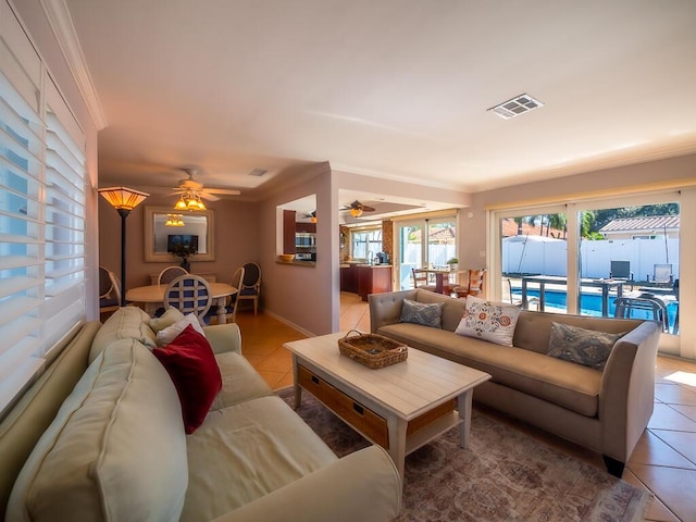 tiled living room featuring ceiling fan and crown molding