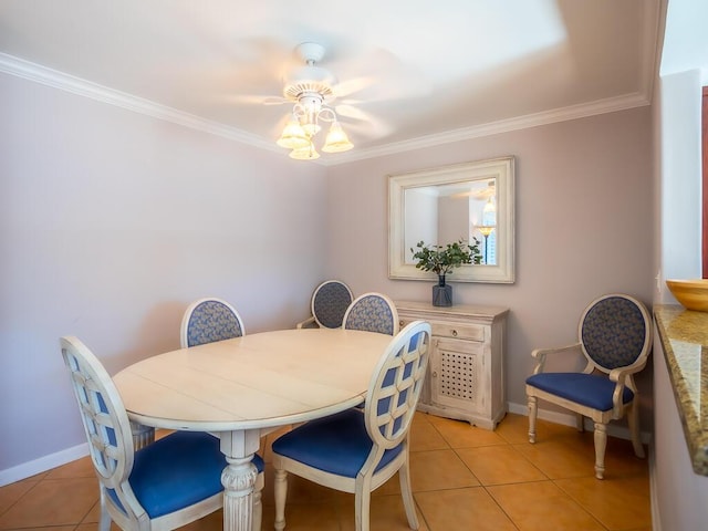 dining area with ceiling fan, light tile patterned floors, and crown molding