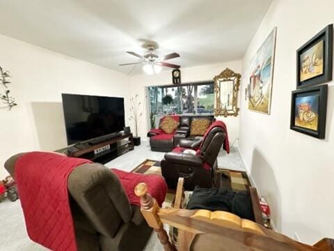 carpeted living room with ceiling fan