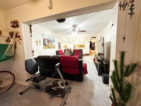 carpeted living room with ceiling fan