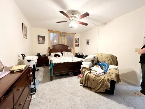 bedroom featuring light carpet and ceiling fan