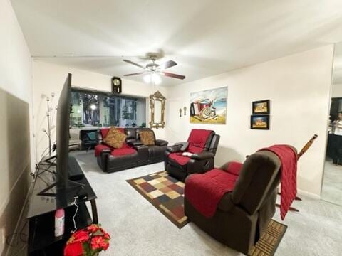 carpeted living room with ceiling fan