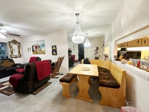 carpeted dining room featuring ceiling fan