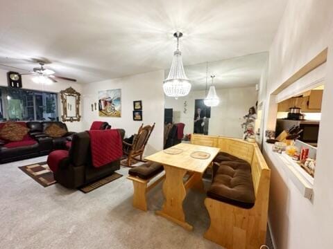 interior space with ceiling fan with notable chandelier