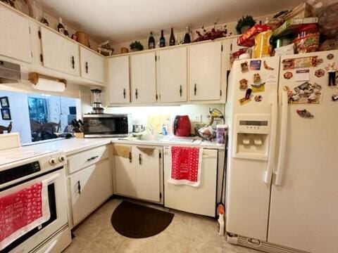 kitchen with light tile patterned flooring, white cabinetry, and stainless steel appliances