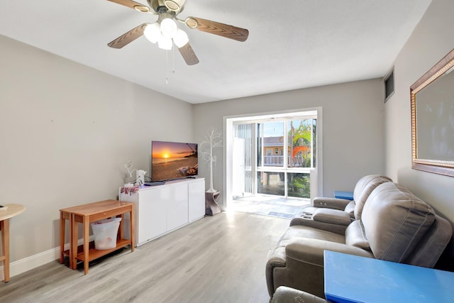 living room featuring ceiling fan and light hardwood / wood-style floors