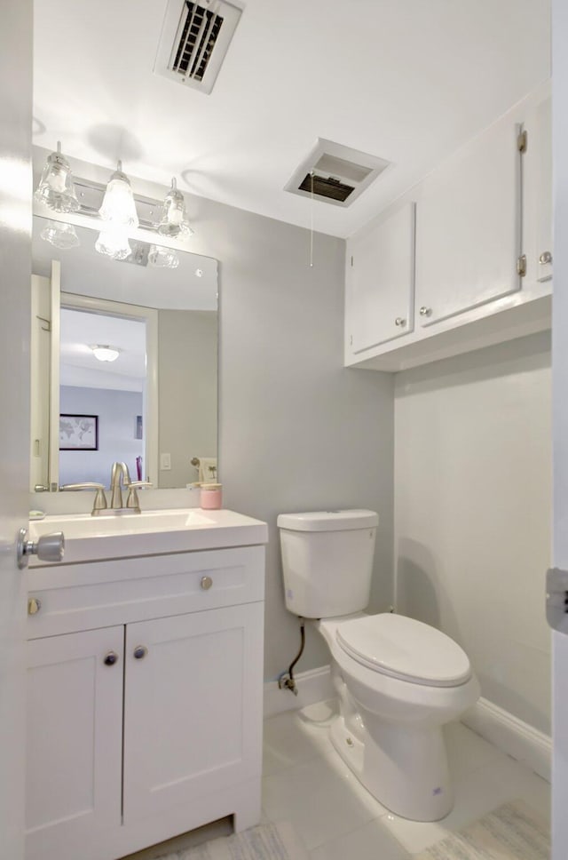 bathroom with tile patterned floors, vanity, and toilet