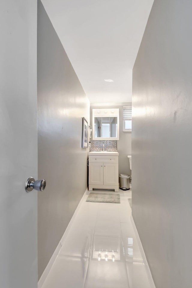 bathroom featuring vanity, backsplash, and tile patterned floors