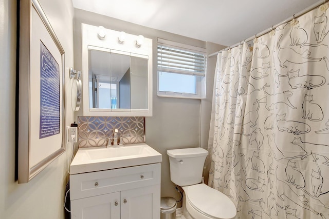 bathroom with backsplash, vanity, a shower with shower curtain, and toilet