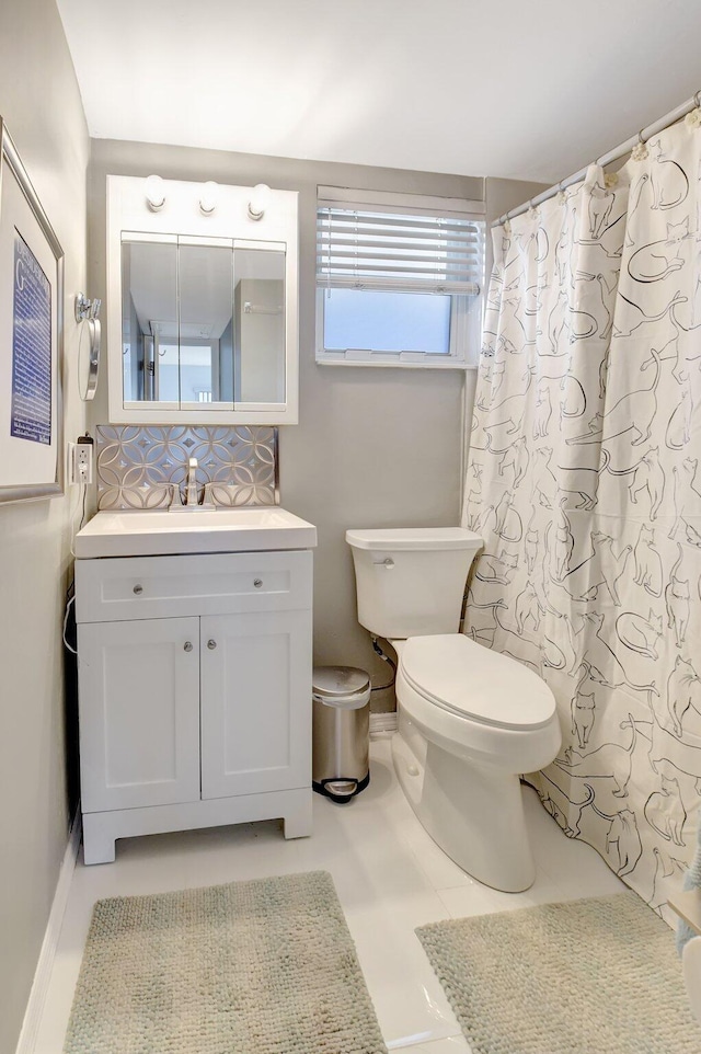 bathroom featuring tile patterned flooring, vanity, and toilet