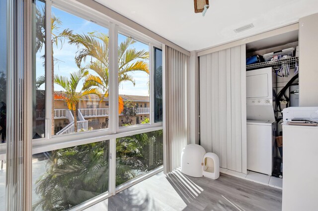 interior space with stacked washer and clothes dryer