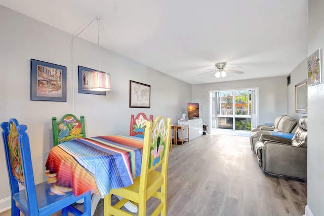 dining space featuring hardwood / wood-style floors and ceiling fan