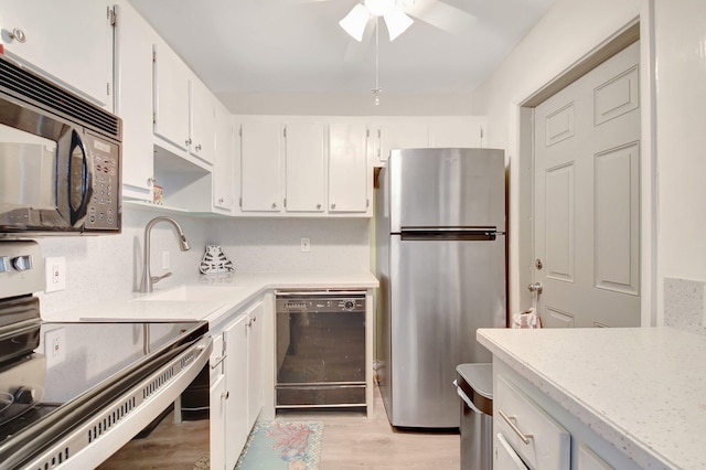 kitchen with white cabinets, light wood-type flooring, and black appliances