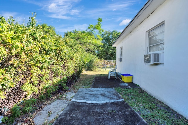 view of yard with cooling unit and a patio