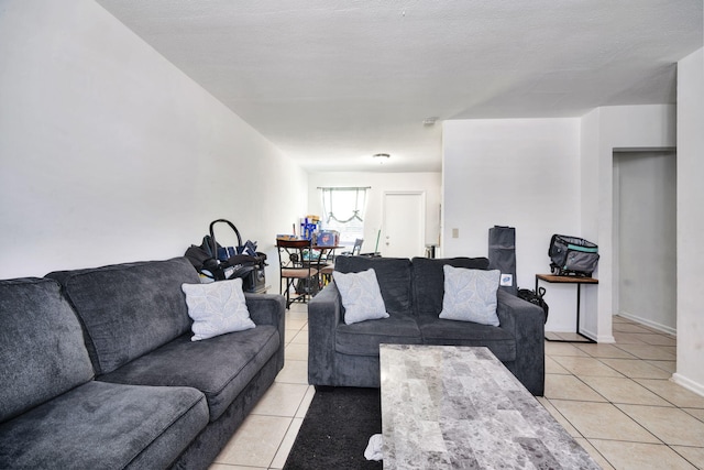 living room with light tile patterned floors and a textured ceiling