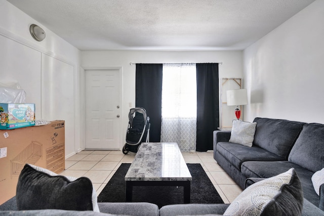 tiled living room featuring a textured ceiling