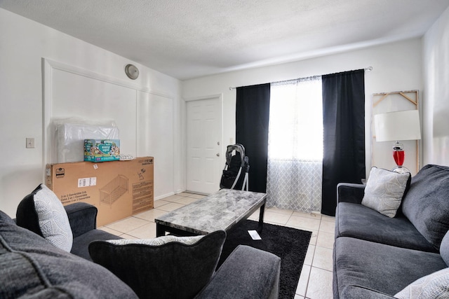 living room with light tile patterned floors and a textured ceiling