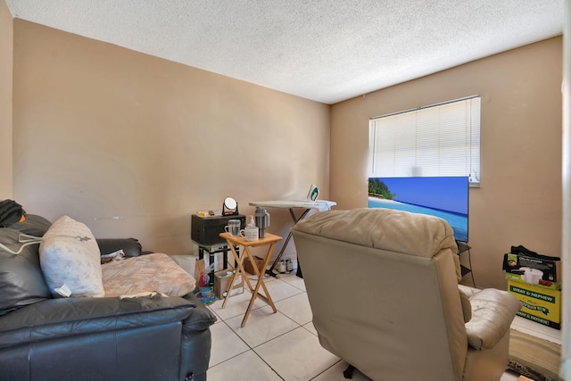 living room featuring a textured ceiling and light tile patterned flooring