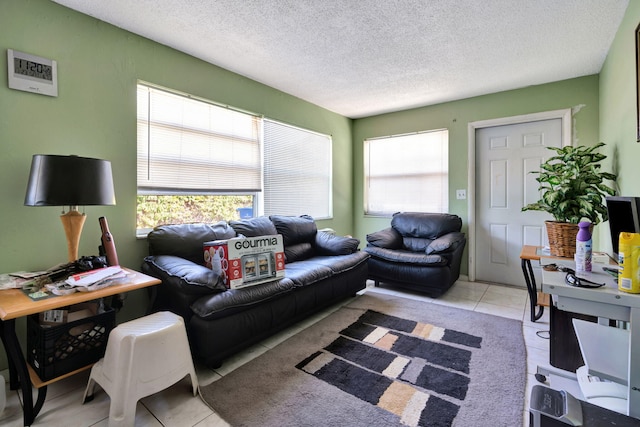 tiled living room featuring a textured ceiling