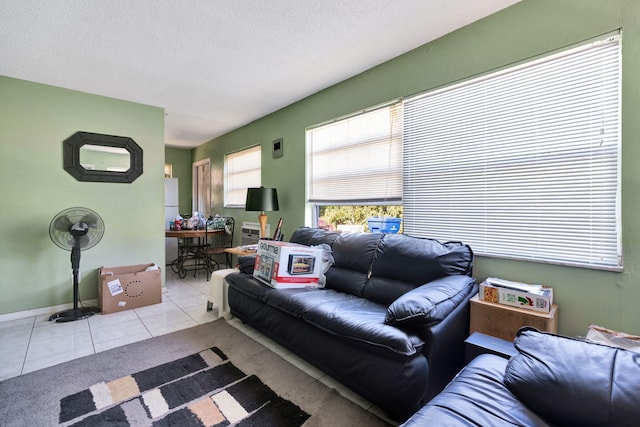 living room with light tile patterned floors and a textured ceiling