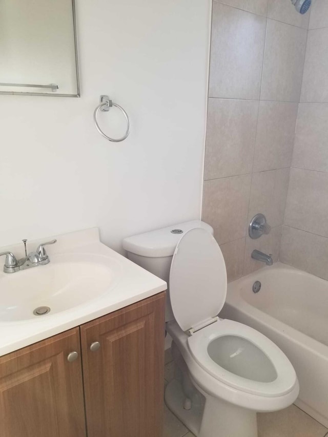 full bathroom with tile patterned floors, vanity, toilet, and tiled shower / bath combo