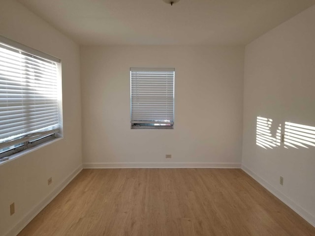 unfurnished room with light hardwood / wood-style floors