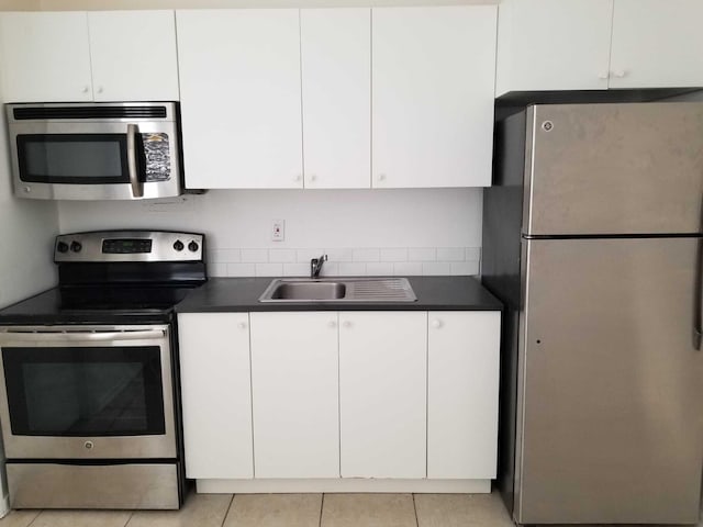 kitchen featuring white cabinetry, light tile patterned flooring, and appliances with stainless steel finishes