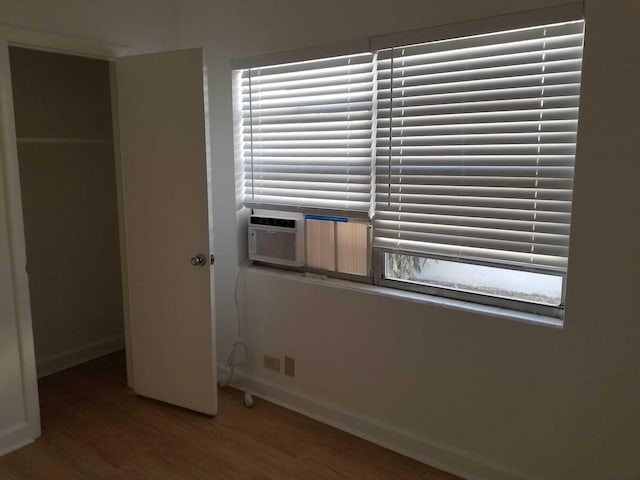 unfurnished bedroom with hardwood / wood-style floors and a closet