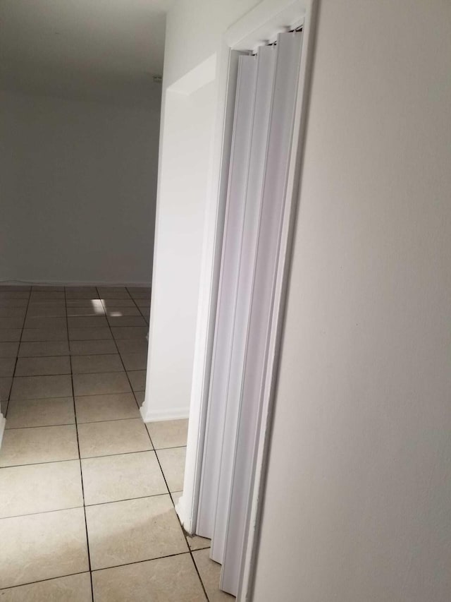 corridor featuring light tile patterned flooring