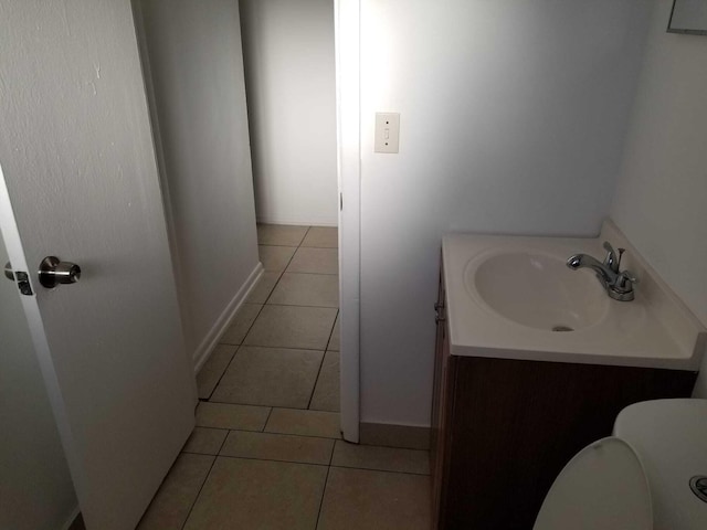 bathroom featuring tile patterned flooring, vanity, and toilet