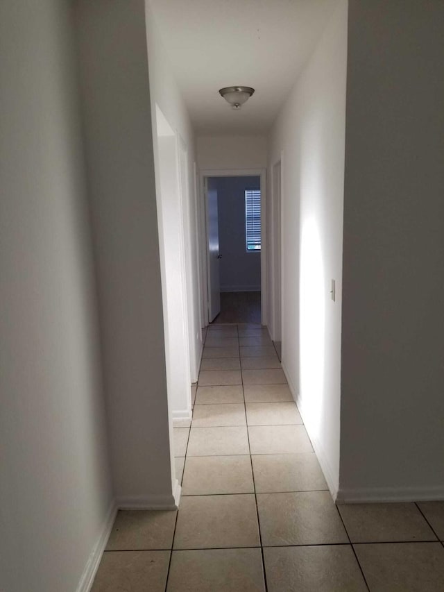 corridor with light tile patterned floors