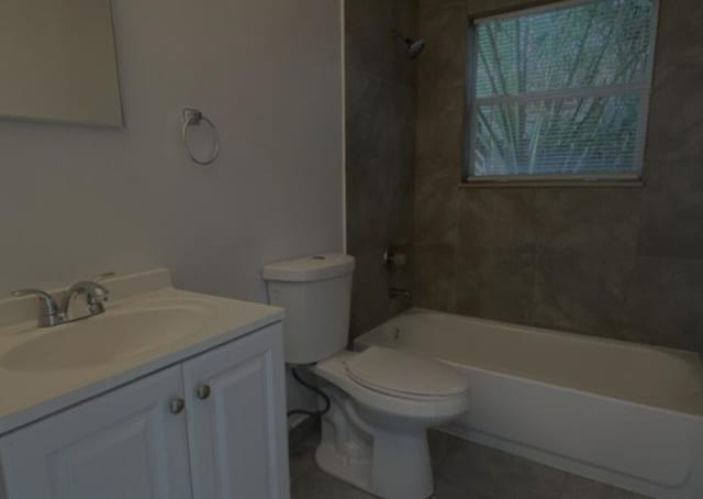 full bathroom featuring tile patterned floors, vanity, toilet, and tiled shower / bath