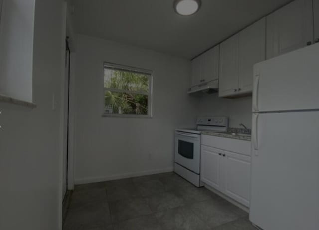 kitchen with white cabinetry, sink, exhaust hood, and white appliances