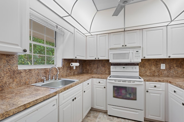 kitchen featuring white appliances, ceiling fan, sink, white cabinetry, and tasteful backsplash