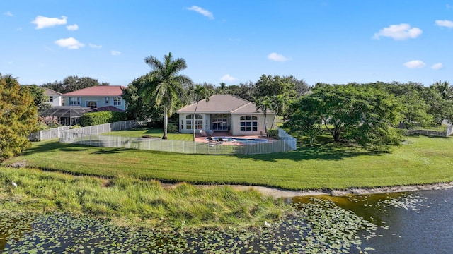 back of property featuring a yard and a water view