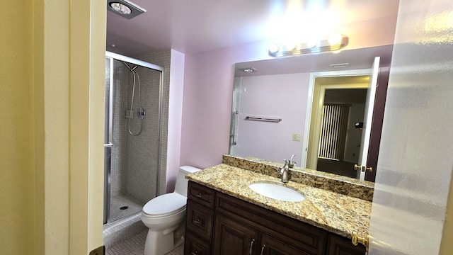 bathroom with tile patterned floors, vanity, toilet, and a shower with door