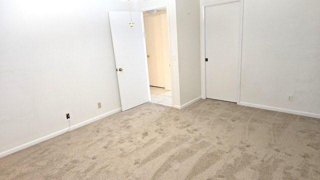 unfurnished room with light carpet