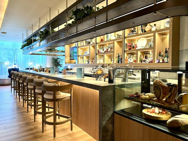 bar with light wood-type flooring